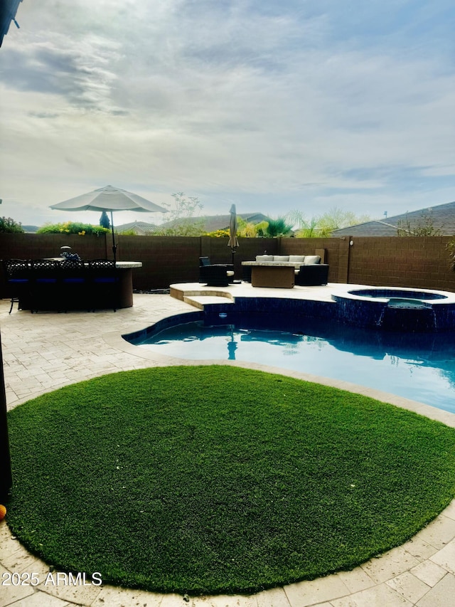 view of swimming pool featuring a fenced backyard, an outdoor living space, a patio area, a lawn, and a pool with connected hot tub