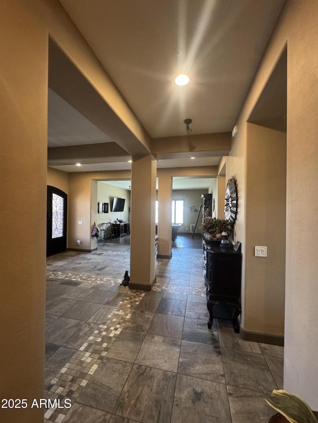 hallway featuring recessed lighting and baseboards