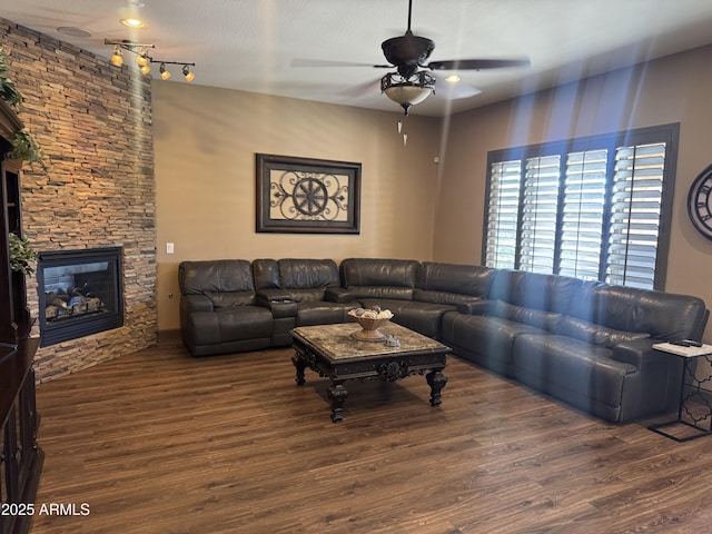 living room with ceiling fan, wood finished floors, and a fireplace