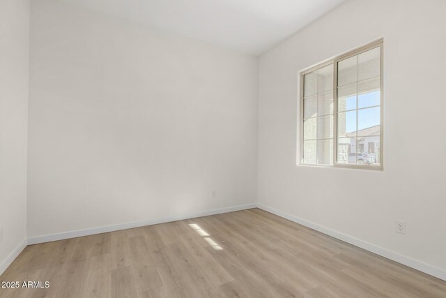 spare room featuring light hardwood / wood-style flooring