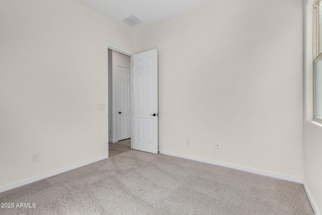 unfurnished room with light colored carpet