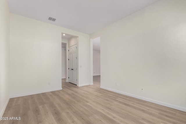 spare room with light hardwood / wood-style flooring