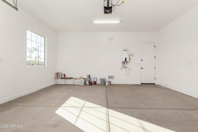 garage with tankless water heater and a garage door opener