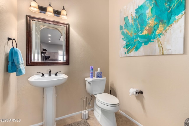 bathroom with tile patterned floors, sink, and toilet