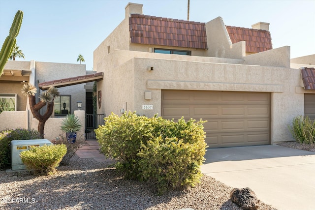 southwest-style home featuring a garage