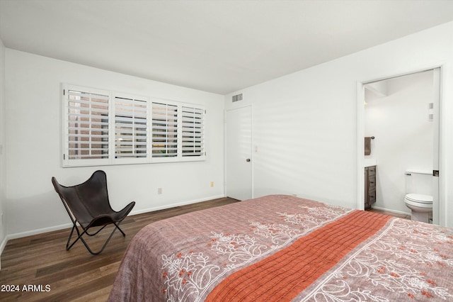 bedroom featuring dark wood-type flooring and connected bathroom