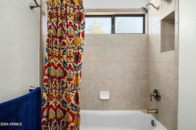 bathroom with shower / tub combo with curtain