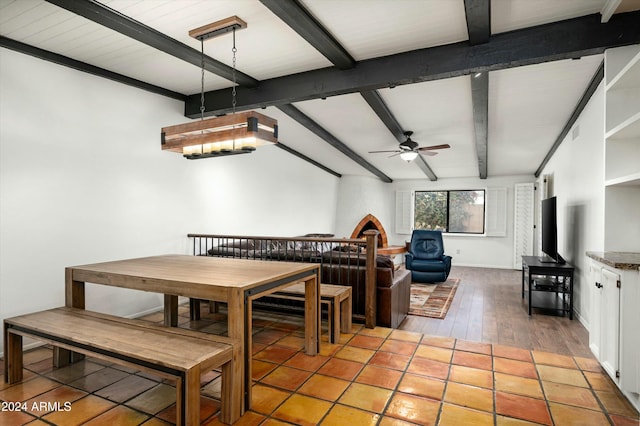 dining area featuring lofted ceiling with beams, ceiling fan, and wood-type flooring