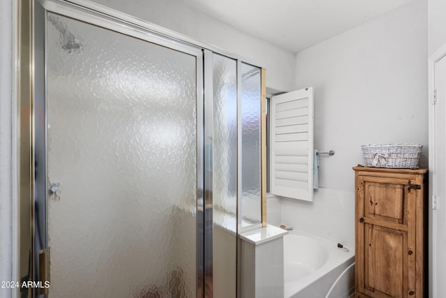 bathroom with separate shower and tub