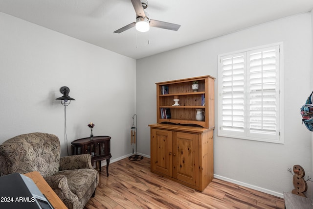 living area featuring ceiling fan and light hardwood / wood-style floors