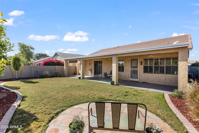 back of house featuring a lawn, a patio area, and ceiling fan