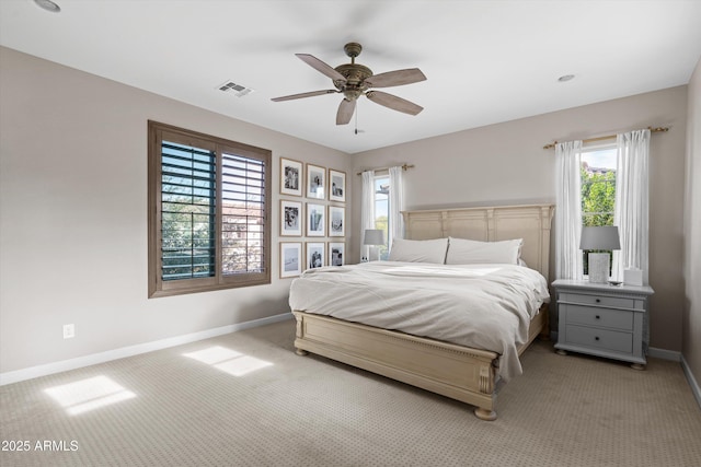 carpeted bedroom with baseboards, visible vents, and a ceiling fan