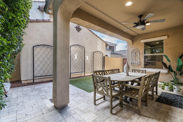 view of patio / terrace with a ceiling fan, outdoor dining area, and fence