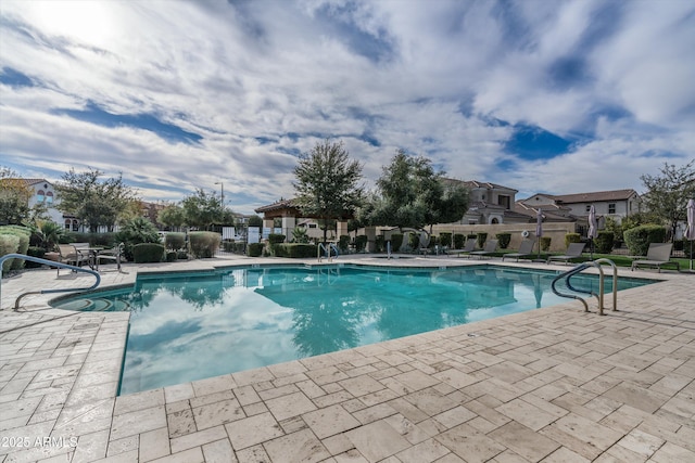 community pool featuring a patio and fence