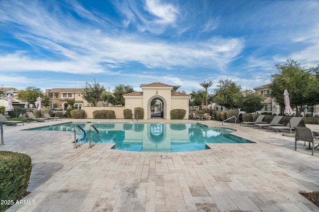 pool featuring a patio and fence