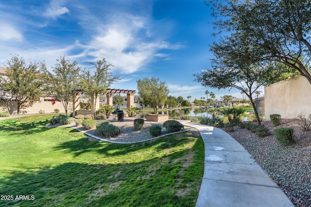 view of yard with a water view and a pergola