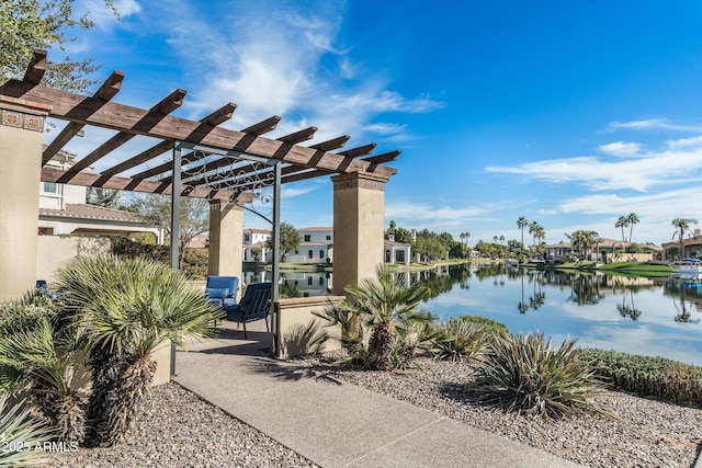 view of patio / terrace featuring a water view and a pergola