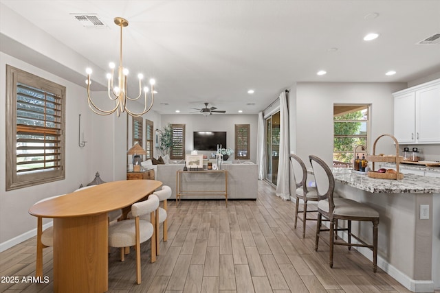 dining space with light wood-style floors, baseboards, visible vents, and recessed lighting