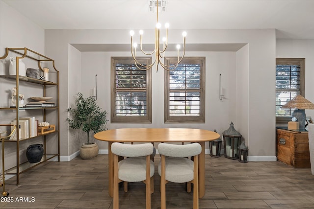 dining room with visible vents, wood finish floors, a chandelier, and a wealth of natural light