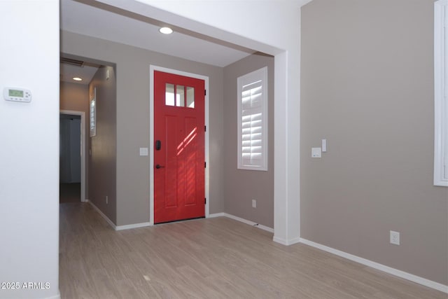 foyer with recessed lighting, light wood-type flooring, and baseboards