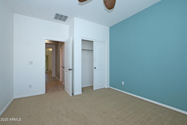 unfurnished bedroom featuring a closet, visible vents, baseboards, and carpet flooring