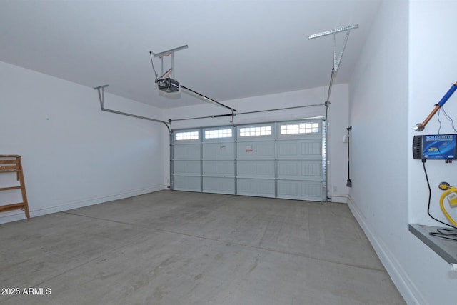 garage featuring baseboards and a garage door opener