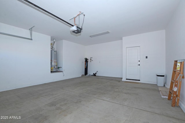 garage with water heater and a garage door opener