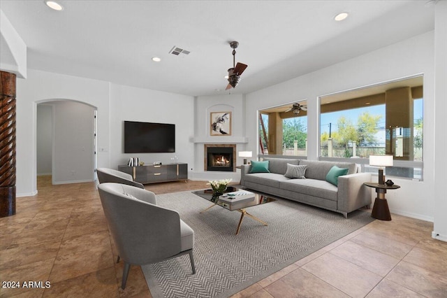 tiled living room with ceiling fan