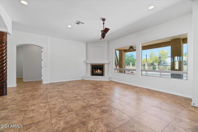 unfurnished living room with ceiling fan and light tile floors