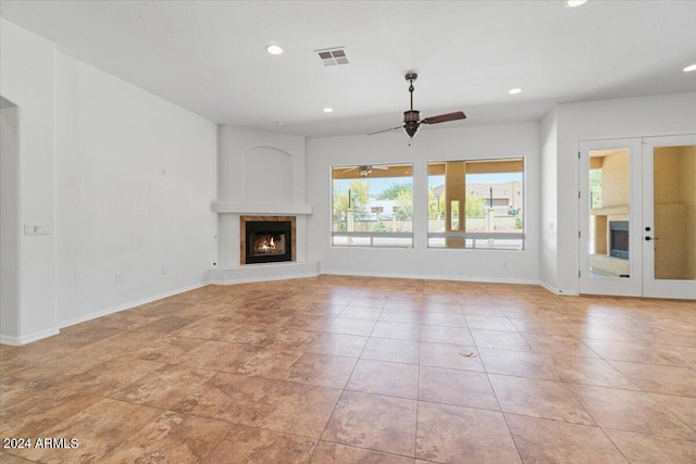 unfurnished living room with french doors, ceiling fan, and light tile floors