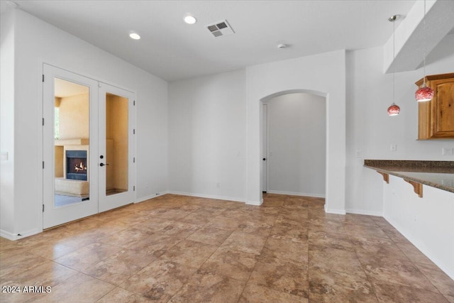 interior space with tile floors and french doors