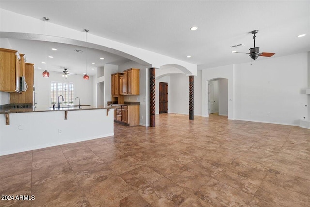 unfurnished living room featuring tile floors and ceiling fan