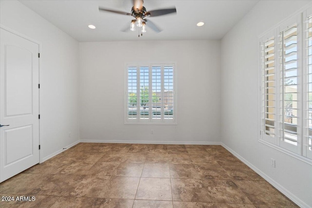 empty room with tile floors and ceiling fan