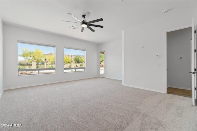 spare room with ceiling fan and carpet flooring