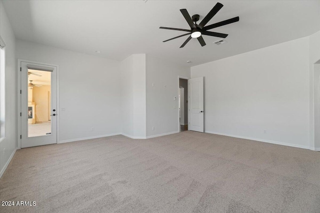 unfurnished room with ceiling fan and light carpet