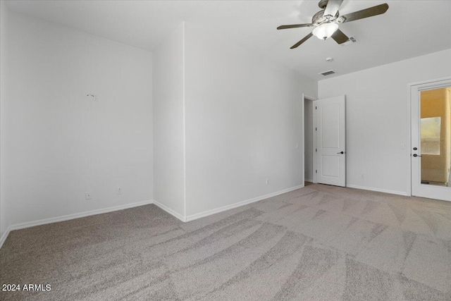 spare room featuring carpet and ceiling fan