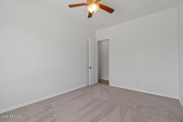 empty room with ceiling fan and carpet floors