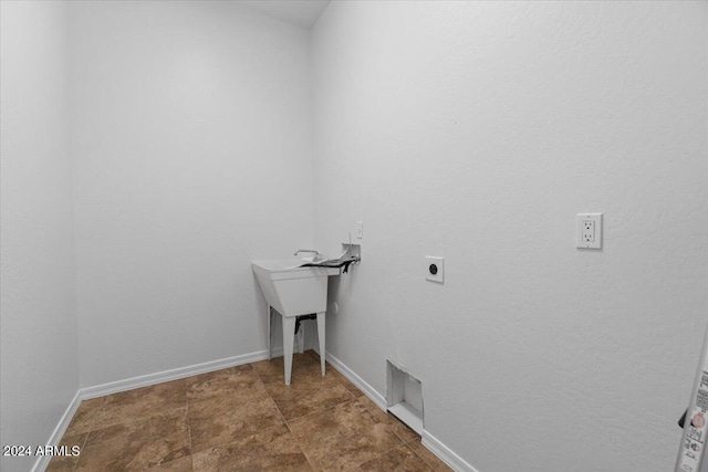 clothes washing area with washer hookup, tile floors, and hookup for an electric dryer