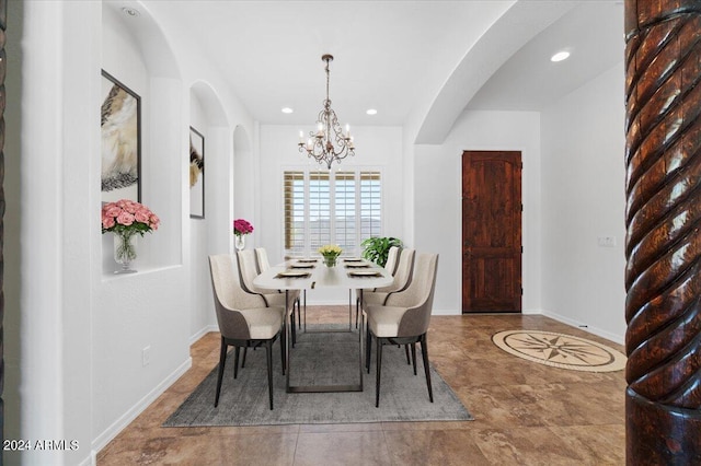 tiled dining room with a notable chandelier