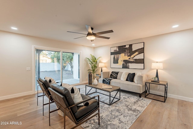 living room featuring ceiling fan and light wood-type flooring