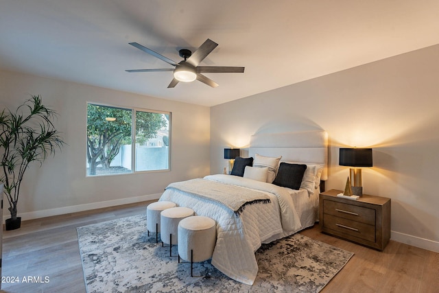 bedroom with ceiling fan and light hardwood / wood-style flooring