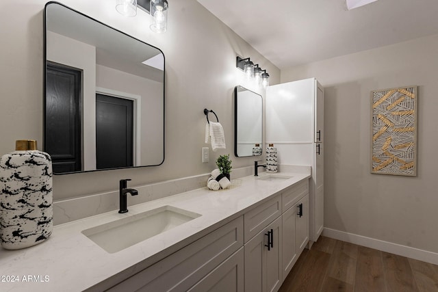 bathroom with vanity and wood-type flooring