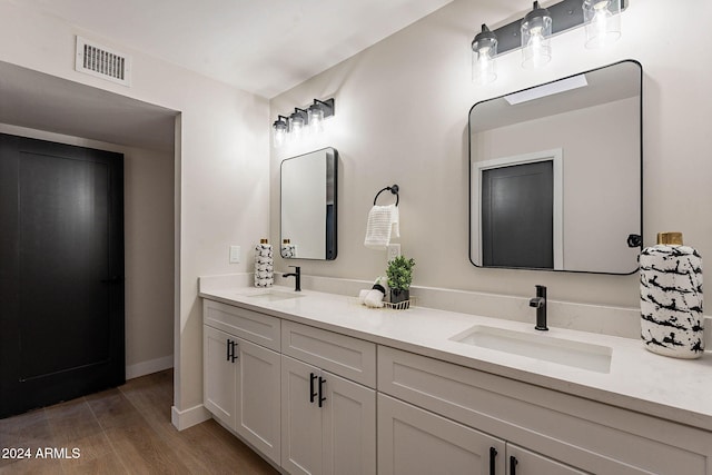 bathroom with hardwood / wood-style floors and vanity