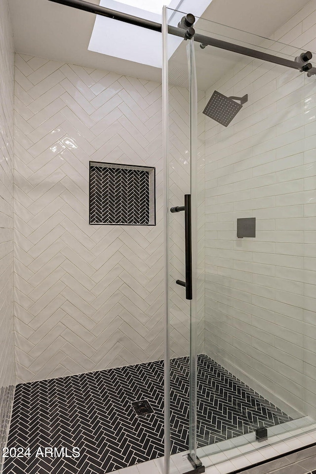 bathroom featuring a shower with shower door