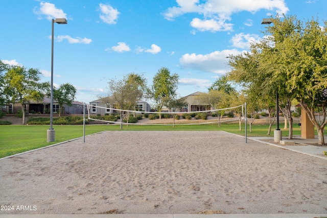 view of property's community featuring a lawn and volleyball court