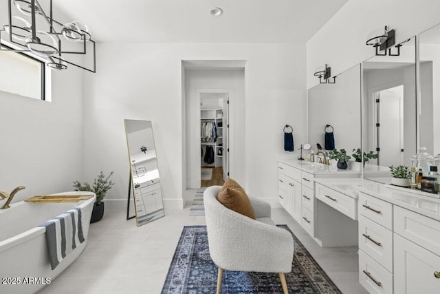 bathroom with a washtub and vanity