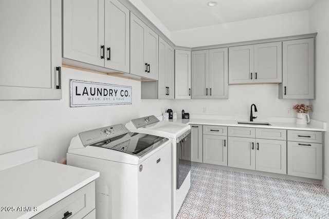 washroom featuring sink, independent washer and dryer, and cabinets