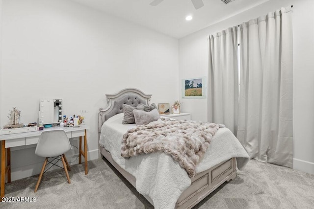 bedroom with ceiling fan, light carpet, and built in desk