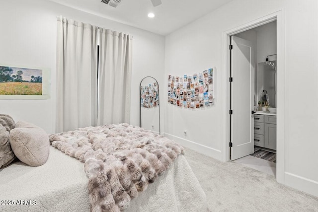 carpeted bedroom with ceiling fan, connected bathroom, and stainless steel refrigerator