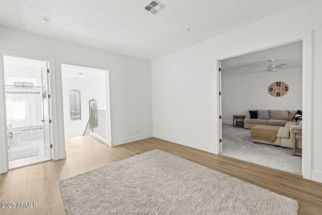 interior space featuring connected bathroom and light hardwood / wood-style flooring